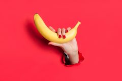 Crop hand holding banana